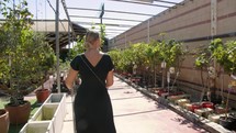 Woman shopping for a tree in a plant nursery