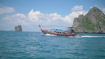 tourists go on boat through paradise in thailand