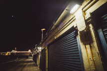 closed garage storage doors at an amusement park at night 