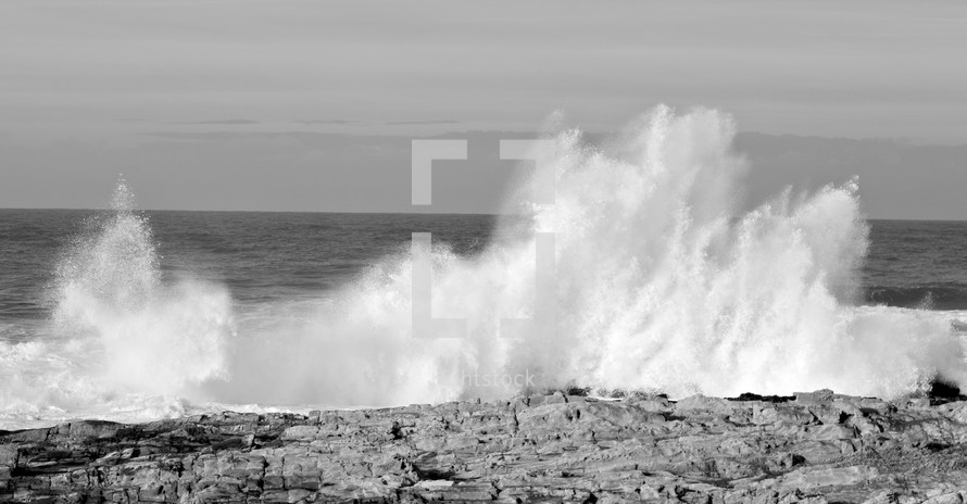 waves crashing into a rocky shore 
