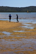 boys walking on a beach in Lokobe Reserve 