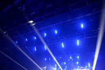 spotlights shining above an audience 