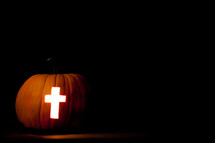 cross carved in a Jack-O-Lantern pumpkin 