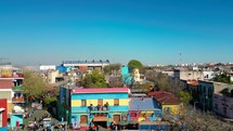 Aerial view of Caminito a famous landmark in La Boca neighborhood in Buenos Aires, Argentina. Drone flying forward
