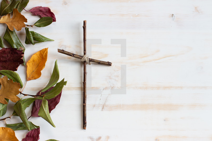 simple cross on a white wood  background 