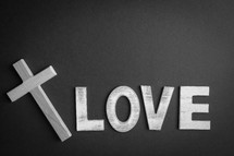 Black background with the word "love" and a cross