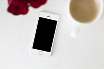iPhone on a white background with coffee mug 
