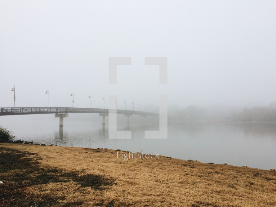 bridge over a lake and fog 