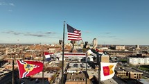 USA and other flags flying high over Saint Louis, Missouri city on a beautiful blue sky day.
