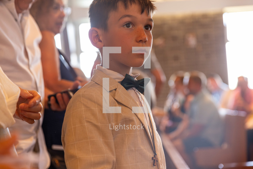 young boy dressed up in church after communion