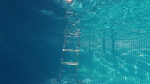 Happy little boys jumping in pool blue clear water, fun for children. Summer swim, underwater leisure. Funny kids, enjoy diving. Extreme angle. High quality 4k footage