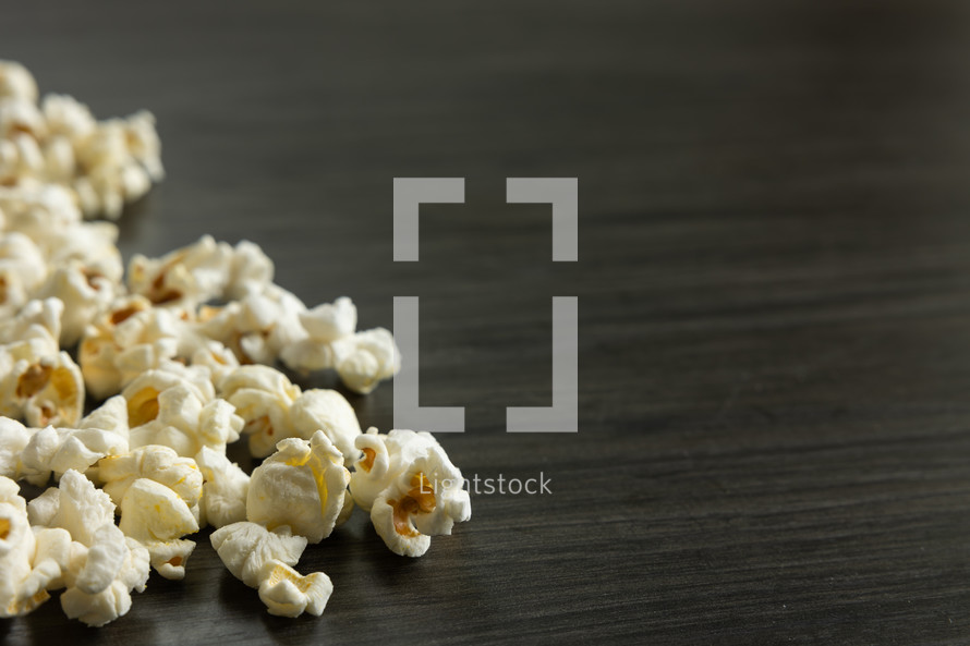 popcorn on a black wood background 