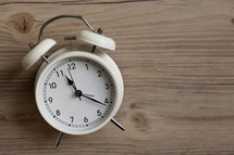 alarm clock on a wood background 