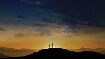 three crosses on a mount at dusk 