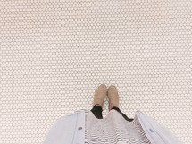 woman standing on white tile floor 