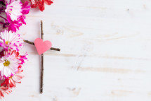 flowers and cross of sticks with heart 