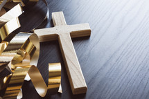gold streamers and cross on a dark background