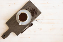 single coffee cup and wood board 