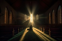 a person kneeling in prayer in church
