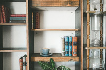 books and coffee cup on a bookshelf 