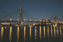 a bridge over a bay at night 