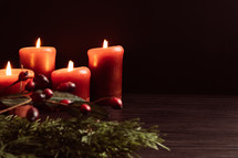Christmas garland with berries and candles