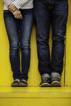 legs of a couple in jeans 