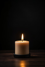A candle on a dark background
