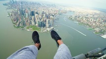 Helicopter tour over New york city with doors off and legs out. Experience on the nyc sky. Concept about travel and transportation