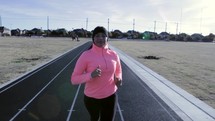 a woman running on a track 
