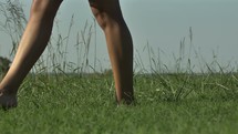 feet walking through tall green grass