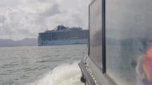 Cruise Ship Tender Approaches Ship Out At Sea
