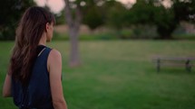 Woman Reading Bible and Journaling Outside at Sunset