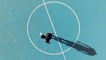 Boy Playing Freestyle Soccer With Ball Overhead View In The Field
