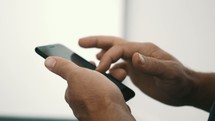 a man scrolling through his phone 