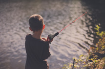 boy child fishing in a lake 