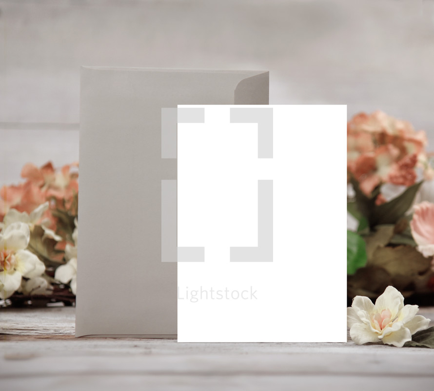 blank white envelope and card with flowers 
