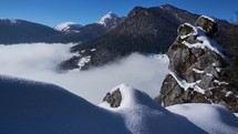 Inverse low clouds holding in a snowy valley in winter frosty time lapse