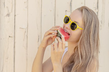 a woman eating a watermelon 