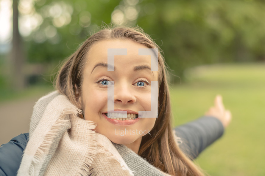 smiling woman pointing 