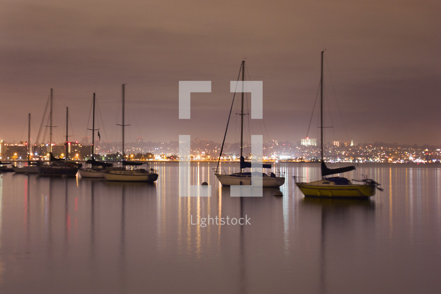 anchored sailboats in a harbor 