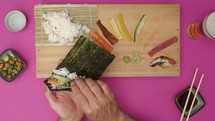 Man preparing sushi roll