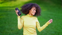 Modern African American Girl Listening To Music By Wireless Portable Speaker