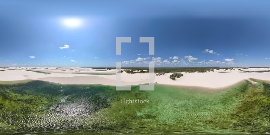 360 aerial photo taken with drone of Lagoa Azul surrounded by sand dunes at midday in Lençóis Maranhenses National Park on the northern coast of Maranhão, Brazil