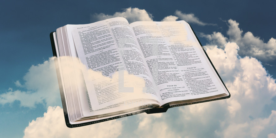 opened Bible in the clouds 