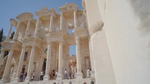Tourists visiting Celsus Library in ancient city Ephesus, Anatolia in Selcuk, Turkey. Slow motion steadicam shot