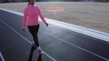 a woman walking on a track 