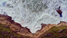 Waves crashing against coastline (slow motion)