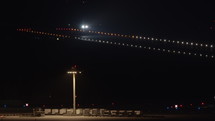 Commercial airplane landing on a runway at night.
