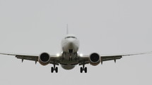Front view of a commercial airplane about to land.